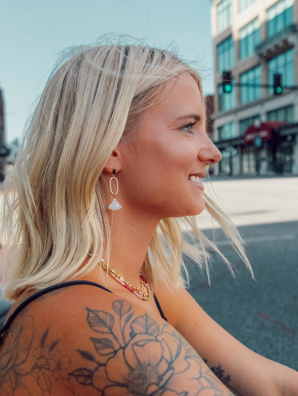 woman smiling looking to the right with kandi earrings on