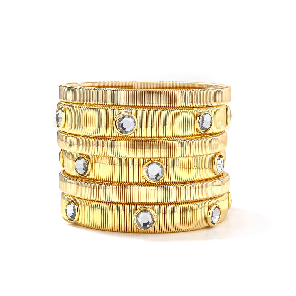 A set of gold-colored bracelets with a textured band and embellished with stones, displayed on a white background.