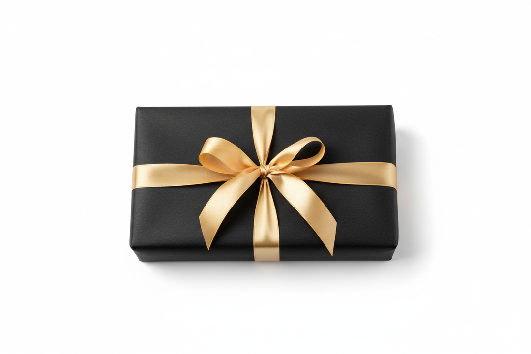 Make a Gift box wrapped in black wrapping paper with gold ribbon and bow. have it sitting with an all white background